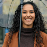 Woman smiling in the rain in Covington and [test_shortcode]